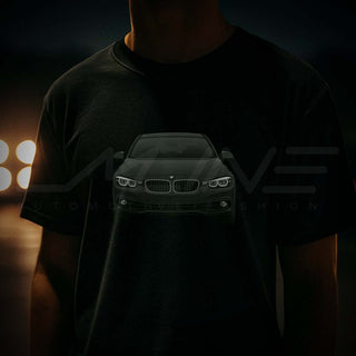 Close-up of M Sedan Cartoon Tee with blurred car headlights glowing in background – gritty streetwear look