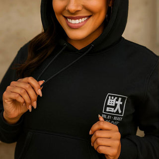 Close-up of hands pulling drawstrings on black M Line Manga Series Vol. 01 hoodie highlighting chest print detail.