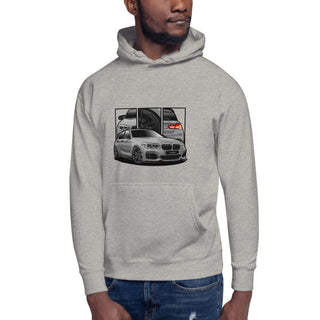 Male model wearing Hot Hatch Legends light grey hoodie with detailed car graphics inspired by the BMW M140i 
