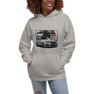 Female model wearing Hot Hatch Legends light grey hoodie with detailed car graphics inspired by the BMW M140i 