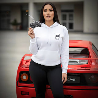 Model holding Ferrari F40 V8 silhouette air freshener next to classic exotic sports car with red bodywork