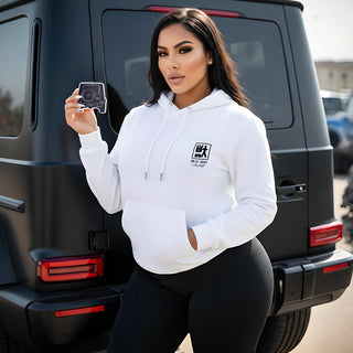 Model holding Mercedes G Wagon G63 G-Series silhouette air freshener beside matte black luxury SUV