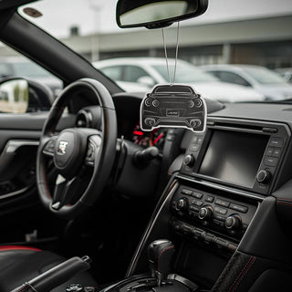 R35 silhouette air freshener hanging from rear-view mirror inside performance car interior