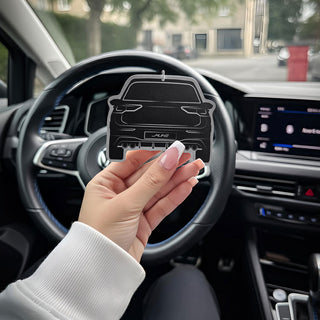 Hand holding VW Golf R Mk8 Silhouette Air Freshener inside car interior, showing scale and premium finish of M Line design.