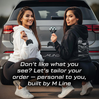 wo Latina models wearing M Line hoodies crouched beside VW Golf R Mk8 – each holding air freshener with text overlay reading ‘Don’t like what you see? Let’s tailor your order — personal to you, built by M Line.’